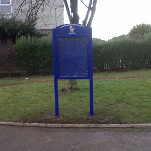 School external post mounted noticeboard with crest and graphics on header panel.