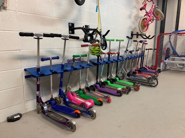 6 space wall mounted scooter rack installed in apartment basement for residents use